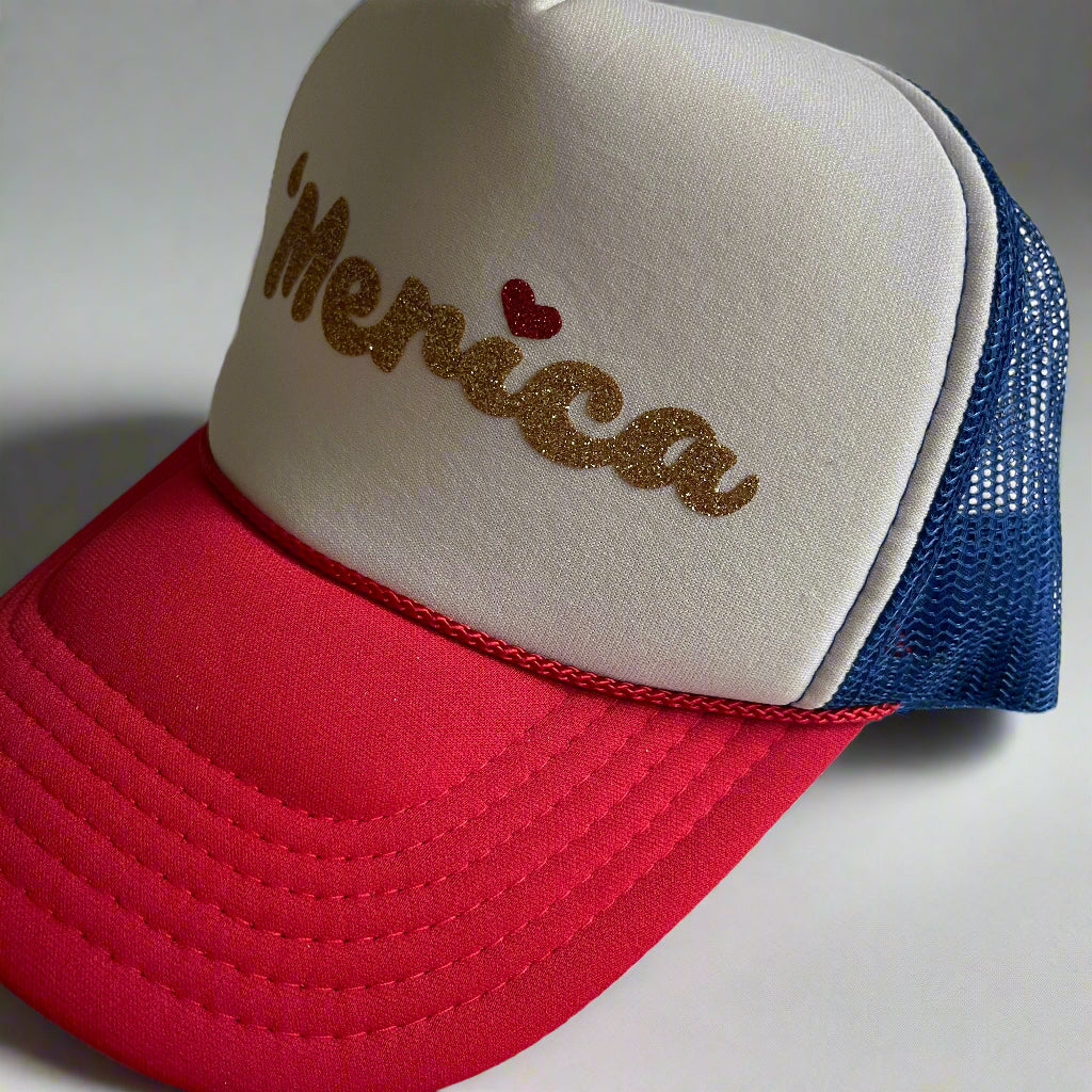 Cap with 'Merica text and heart on beige, red, and blue mesh design.